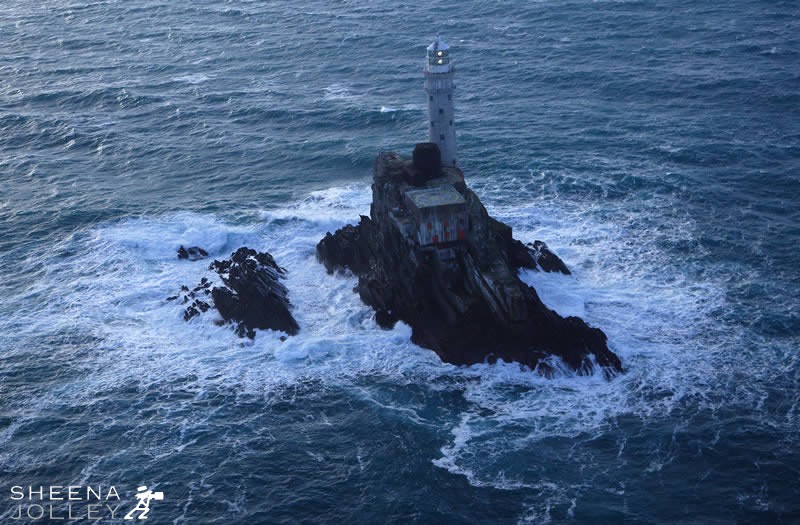 The Fastnet Rock Never Sleeps.jpg - A tense moment as an approaching storm is looming turning the clouds an inky blue and whipping up the ocean waves. Lift off by helicopter just in time